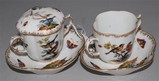 A pair of Augustus Rex cups and saucers (one lid)